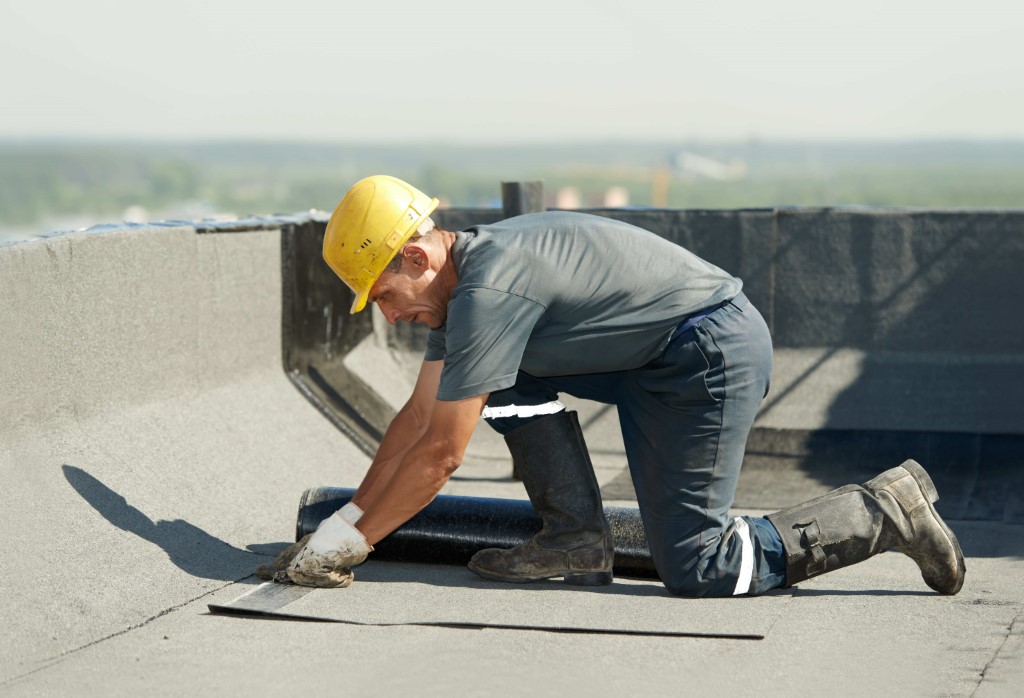 Contractor performing roof repair.